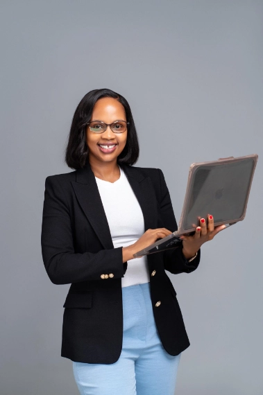 Skin Reveal Aesthetics Founder Holding a Laptop - MIlkah Wambui